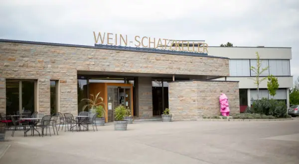 Die Genossenschaftskellerei Heilbronn lädt zu Veranstaltungen ein. Vor dem Gebäude steht eine pinke Gartenzwerg-Skulptur.