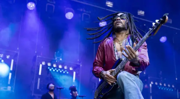 Lenny Kravitz 2023 rockt die Bühne mit seiner Bassgitarre, die Dreadlocks fliegen im Scheinwerferlicht.